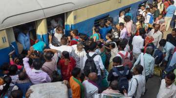 People board a train to reach their hometowns ahead of Diwali festival