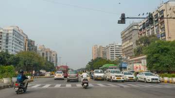 Vehicles move down a road amid clear weather conditions, in New Delhi.