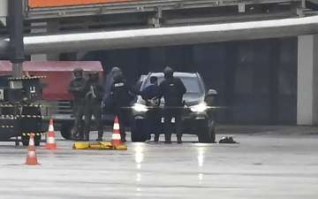 The hostage-taker being taken away by police at the Hamburg Airport on Sunday.