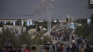 Palestinians flee to the southern Gaza Strip on Salah al-Din Street in Bureij, Gaza Strip.