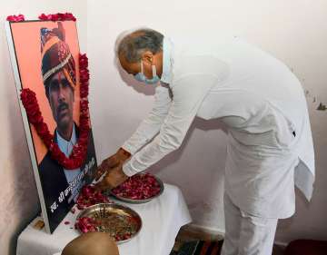 Rajasthan Chief Minister Ashok Gehlot pays tribute to tailor Kanhaiya Lal, who was killed by two men allegedly over his social media post, at his residence in Udaipur
