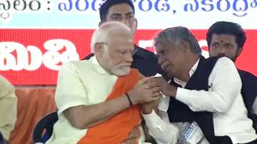 Prime Minister Narendra Modi consoles Madiga leader during poll rally in Hyderabad's Secunderabad.