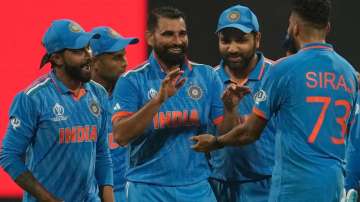 Indian team celebrates after a wicket in Mumbai.