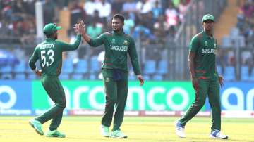 Shakib Al Hasan (centre) celebrating a wicket with teammates.