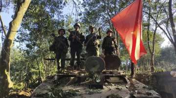 Members of the Myanmar National Democratic Alliance Army hold the group’s flag 