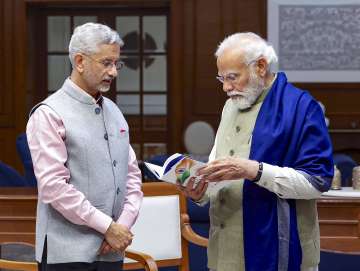 PM Modi with EAM S Jaishankar showcasing his newly launched book.