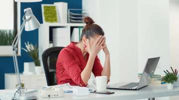 Woman holding her head in stress