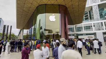 Customers stand in a queue outside an Apple retail store in Mumbai.