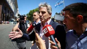 Argentina's Minister of Economy Luis Caputo speaks to the press