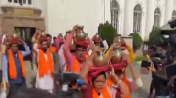 Bengal BJP MLAs carry 'gangajal' to 'clean' the Ambedkar Statue on the premises of West Bengal assembly after TMC lawmakers protested at the site.