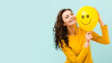 Woman smiling with smiley balloon