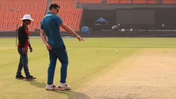 Pat Cummins inspecting Narendra Modi Stadium's surface