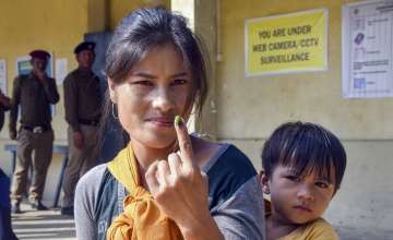 A voter shows her finger marked with indelible ink after casting her vote for Mizoram Assembly elections.