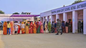 People stand in queue at a polling booth to cast vote during Rajasthan Assembly elections (File photo)