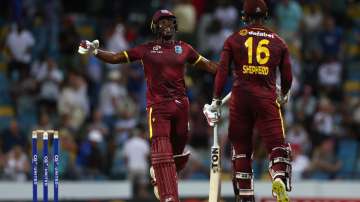 Matthew Forde and Romario Shepherd celebrate after securing the ODI series against England.