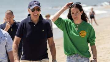 US President Joe Biden walks on the beach with daughter Ashley Biden.