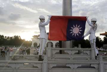 Soldiers preparing to pace a Taiwanese flag.