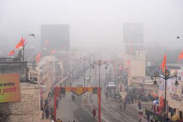 People at the Ram Path amid fog on a cold winter morning in Ayodhya