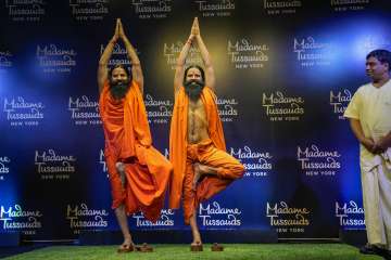 Yoga guru Ramdev poses for photos with his wax figure unveiled by Madame Tussauds New York in New Delhi.