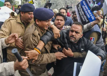 Security personnel stand guard AAP and Congress councillors