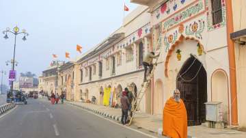 Artisans create murals to decorate buildings located along the Ram Path ahead of the consecration ceremony of the Shri Ram Janmabhoomi Temple, in Ayodhya.