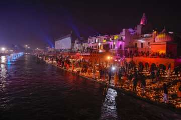 Devotees at the illuminated Saryu Ghat with earthen lamps (diyas) to mark the consecration ceremony of Ram Temple, in Ayodhya.