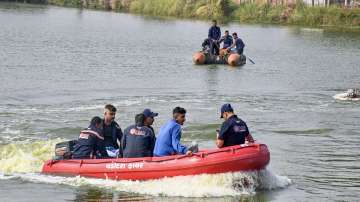 Gujarat Forensic Science Laboratory (FSL) team inspects the site where a boat carrying school students capsized in a lake in Vadodara.