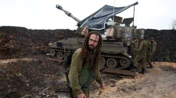 An Israeli soldier stands by a mobile artillery unit, near the Israel-Lebanon border, in northern Is