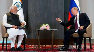 Russian President Vladimir Putin, right, speaks to Prime Minister Narendra Modi during their talks o