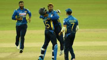 Akila Dananjaya celebrates a wicket with his teammates.