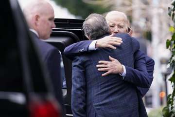 US President Joe Biden while giving a tight hug to his son Hunter Biden.