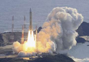 An aerial view shows a second test model of H3 rocket lift-off from the launching pad at Tanegashima