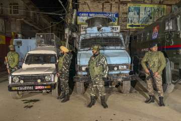 Security personnel stand guard during a cordon and search operation after terrorists shot dead a worker from Punjab while another sustained injuries in the Habba Kadal area