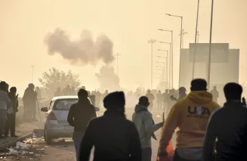 Police use tear gas to disperse protesting farmers gathered at the Punjab-Haryana Shambhu border during the second day of their Delhi Chalo march near Patiala