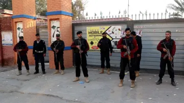 Pakistan elections 2024: Police officers stand guard outside a polling station in Gulbahar area in P