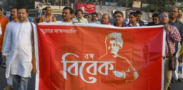 People hold a banner during a protest march against Sandeshkhali case, in Kolkata
