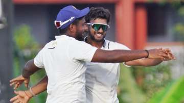 Jalaj Saxena celebrates a wicket with Sanju Samson.