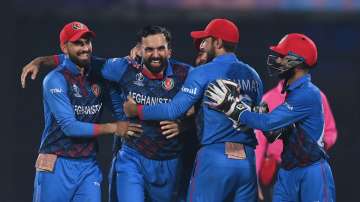 Mohammad Nabi celebrates a wicket with the rest of his Afghan teammates.