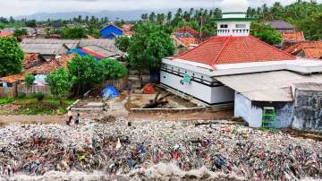 A drone view shows trash being swept to the shore due to high tides caused by erratic weather, on a beach in Teluk fishing village, in Pandeglang regency.