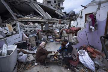Palestinians break their fast amid the rubble of their destroyed home during the Muslim holy fasting