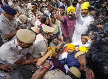 AAP workers during their protest outside Patel Chowk metro station against the arrest of Delhi CM Arvind Kejriwal in New Delhi