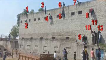 Several men climb exam centre wall to make students cheat in Haryana's Nuh.