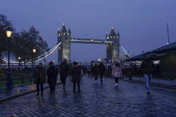 People walk outside the Tower of London, as the Tower Bridge stands on the river Thames, in London. (Representational image)