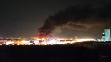 Smoke rises above the Crocus City Hall concert venue following a reported shooting incident on the outskirts of Moscow. 