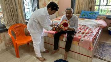 BJP candidate Arjun Singh (left) seeks blessings of ailing TMC veteran Mukul Roy (right) for polls
