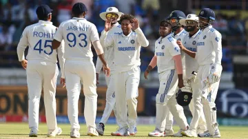 Kuldeep Yadav celebrates a wicket with his teammates.