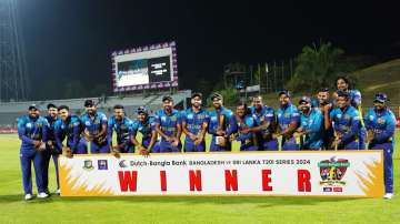 Sri Lankan players pose with the series trophy.