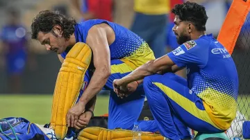 Ruturaj Gaikwad sitting alongside MS Dhoni during a CSK practice session.