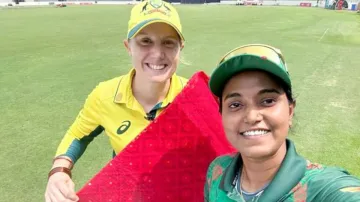 Alyssa Healy poses with a saree alongside Nigar Sultana Jyoti.