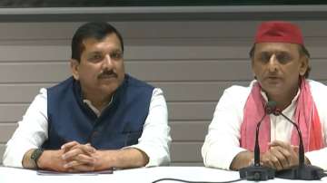 AAP leader Sanjay Singh and Samajwadi Party chief Akhilesh Yadav